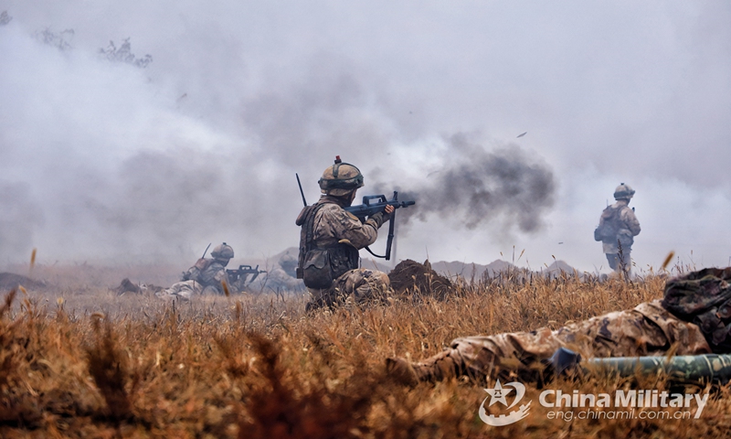 Service members assigned to a combined-arms brigade with the army under the PLA Central Theater Command shoot at the enemy to provide cover for the wounded during a real combat medical support training exercise on November 28, 2022. (eng.chinamil.com.cn/Photo by Yan Qizhao)