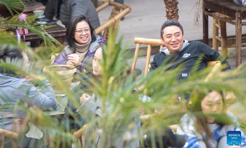 Tourists rest at Shancheng Alley of the Jiefangbei business district in Chongqing, southwest China, on Dec. 24, 2022. (Xinhua/Tang Yi)