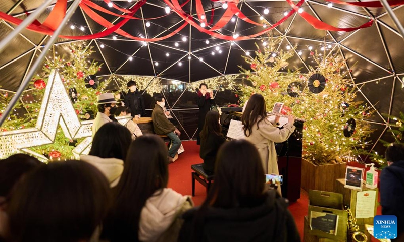 People enjoy a music show to celebrate Christmas and upcoming new year at the Ebisu Garden Place in Ebisu, Tokyo, Japan, Dec. 25, 2022. (Xinhua/Zhang Xiaoyu)