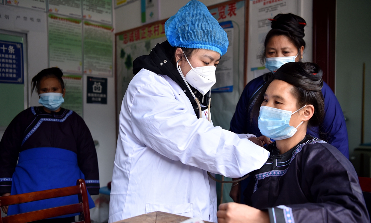 A doctor is examining the health condition of a villager in rural areas of Southwest China's Guizhou Province on December 25, 2022. Photo: VCG