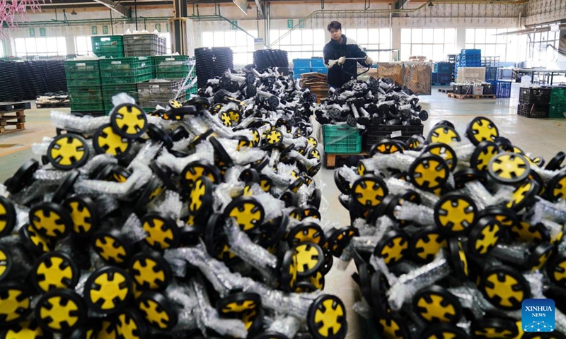 A worker transports baby stroller components at a factory of a bicycle and baby stroller manufacturer in Pingxiang County, north China's Hebei Province, Dec. 27, 2022. As the end of the year approaches, bicycle and baby stroller manufacturers in Pingxiang County of Hebei Province have stepped up production to guarantee the completion of orders from domestic and foreign customers.(Photo: Xinhua)