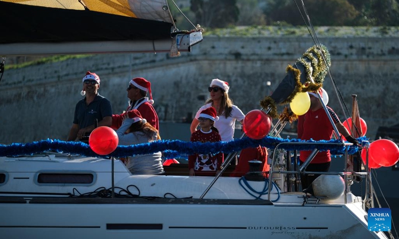 People take part in the traditional Boxing Day Fun Race for charity in Ta' Xbiex, Malta, on Dec. 26, 2022.(Photo: Xinhua)