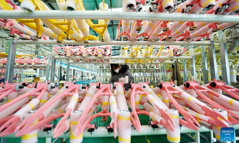 A worker arranges bike racks at a factory of a bicycle and baby stroller manufacturer in Pingxiang County, north China's Hebei Province, Dec. 27, 2022. As the end of the year approaches, bicycle and baby stroller manufacturers in Pingxiang County of Hebei Province have stepped up production to guarantee the completion of orders from domestic and foreign customers.(Photo: Xinhua)