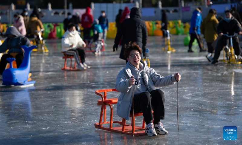 People play on the frozen Shichahai lake which has been turned to an ice rink in Beijing, capital of China, Dec. 27, 2022. The ice rink opened to the public on Tuesday.(Photo: Xinhua)