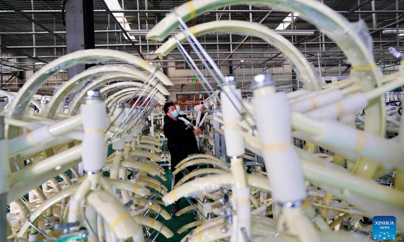 A worker checks the quality of products at a factory of a bicycle and baby stroller manufacturer in Pingxiang County, north China's Hebei Province, Dec. 27, 2022. As the end of the year approaches, bicycle and baby stroller manufacturers in Pingxiang County of Hebei Province have stepped up production to guarantee the completion of orders from domestic and foreign customers. (Photo: Xinhua)