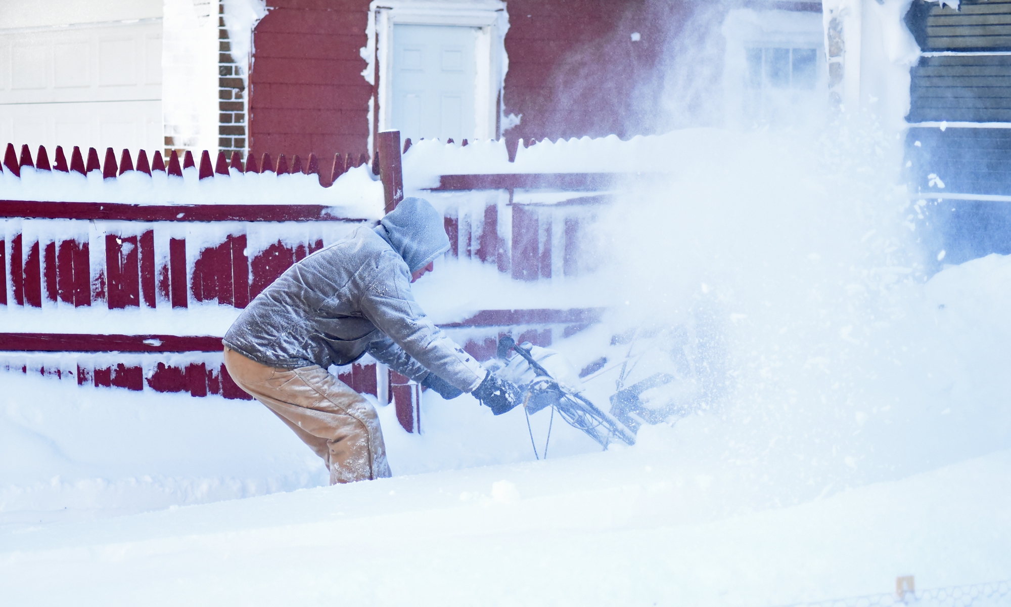 Photo shows a man clears heavy snow in front of his house. At least 12 people are confirmed dead as a once in a generation blizzard dropped 4 to 5 feet of snow, produced 60-70 MPH winds, caused power outages and road closures throughout Western New York. Photo: VCG