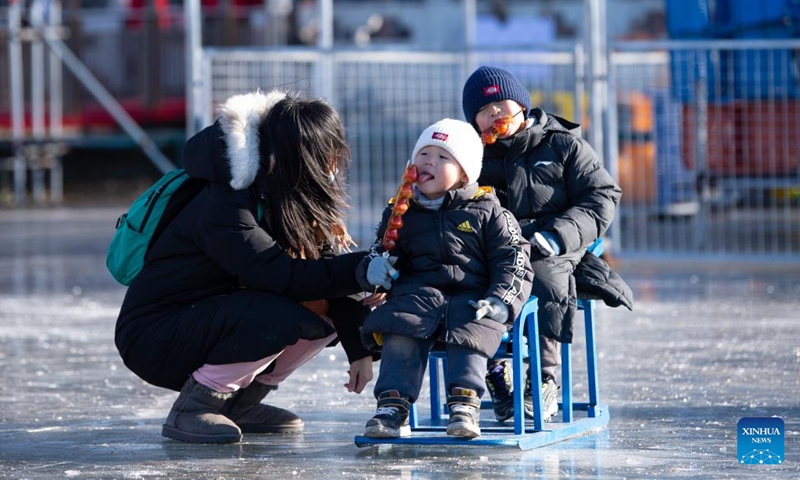 People play on the frozen Shichahai lake which has been turned to an ice rink in Beijing, capital of China, Dec. 27, 2022. The ice rink opened to the public on Tuesday.(Photo: Xinhua)