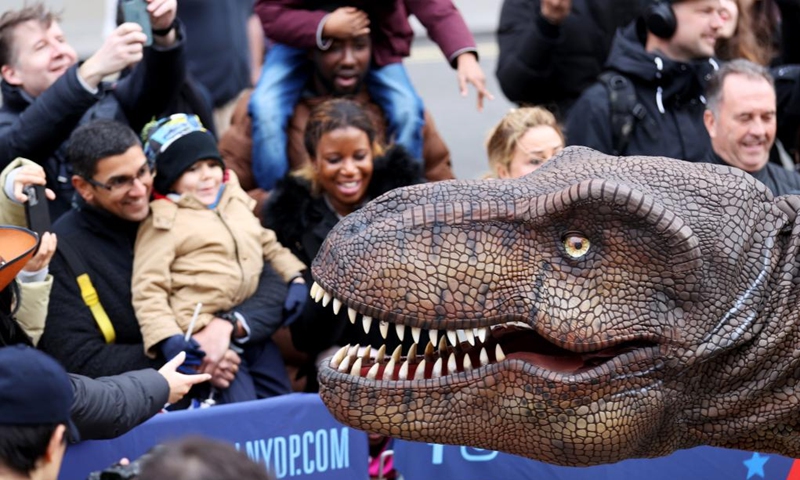 People interact with a dinosaur during the annual New Year's Day Parade in London, Britain, Jan. 1, 2023. (Xinhua/Li Ying)