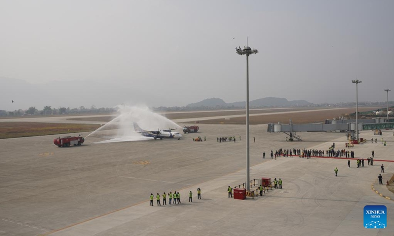 A Buddha Air flight is saluted with water cannon when it lands at Pokhara International Airport in Pokhara, Nepal, Jan. 1, 2023. As Pokhara International Airport, a national pride project of Nepal, was inaugurated on Sunday, Nepali Prime Minister Pushpa Kamal Dahal laid emphasis on its contribution to national and regional development. (Photo by Hari Maharjan/Xinhua)