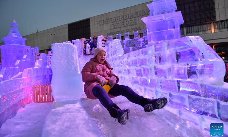 A girl plays on an ice slide at an ice sculpture exhibition in Moscow, Russia, on Jan. 5, 2023.(Photo: Xinhua)