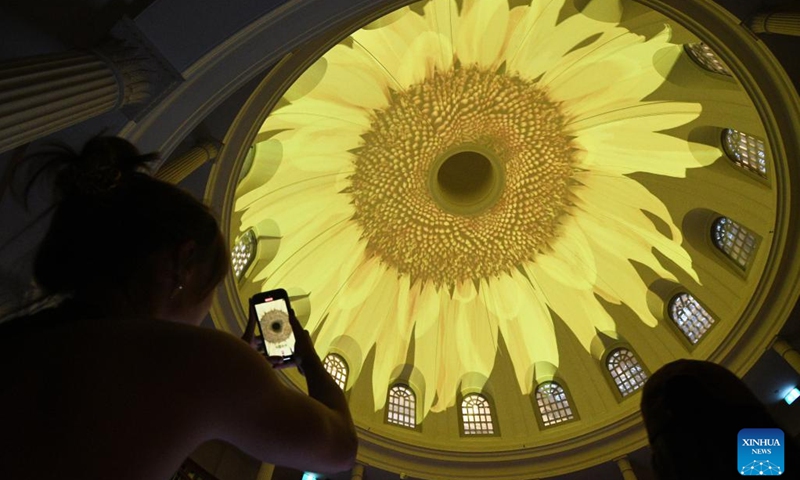 A visitor takes a photo of a light installation during a media preview of the Light to Night Festival at Singapore's Civic District, Jan. 4, 2023. The Light to Night Festival will be held from Jan. 6 to 26 in various locations in the Civic District.(Photo: Xinhua)