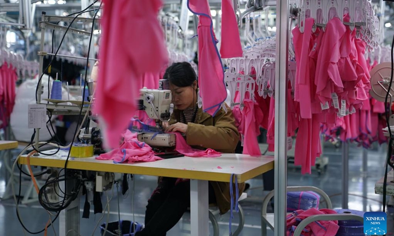 An employee works at a clothing company in Nanchang, east China's Jiangxi Province, Jan. 4, 2023. With production lines humming and machines running in full swing, factories across China have resumed busy operation after the country's latest optimization of COVID-19 response and a series of measures to accelerate production resumption.(Photo: Xinhua)