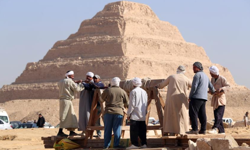 People work at an archaeological excavation site of ancient tombs in Saqqara necropolis, south of Cairo, Egypt, on Jan. 26, 2023. Egypt's renowned archeologist Zahi Hawass on Thursday announced the discovery of 