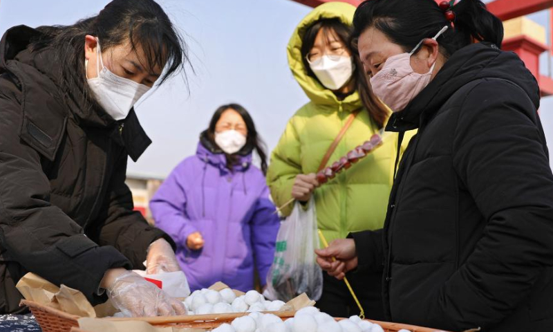 People purchase Yuanxiao, sweet glutinous rice dumplings for celebrating the Lantern Festival, at a country fair in Yingkou, northeast China's Liaoning Province, Feb. 5, 2023. People celebrate the Lantern Festival, the 15th day of the first month of the Chinese lunar calendar, with various traditional customs across the country. Photo: Xinhua