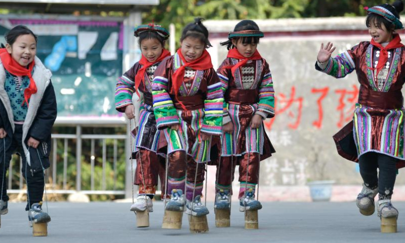 Students take part in a stilts match at the Zhongzhai education spot in Xishan Town of Congjiang County, Qiandongnan Miao and Dong Autonomous Prefecture, southwest China's Guizhou Province, Feb. 16, 2023. Zhongzhai education spot, located in the remote mountainous area of Guizhou Province, has only one teacher and 16 students of Yao ethnic group. In recent years, the conditions of this mini primary school have been greatly improved with the help of local government and community. Photo: Xinhua