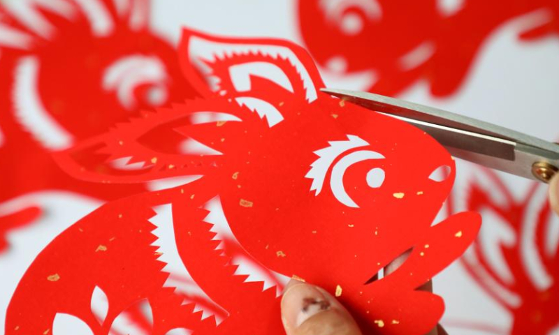 A folk artist creates rabbit-themed paper cutting works in Lizhuang Town, Huimin County, Binzhou City, east China's Shandong Province, Jan. 13, 2023. The Chinese New Year for 2023 marks the Year of the Rabbit -- a gentle and beloved animal that signifies vitality, wittiness, cautiousness and good luck in the Chinese zodiac. (Photo by Chu Baorui/Xinhua)