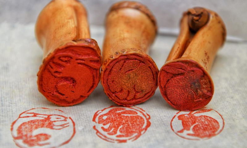 This photo taken on Jan. 19, 2023 shows rabbit-themed seals carved with bamboo roots by Zhang Donghua, inheritor of Wuyi bamboo carving, in Wuyishan City, southeast China's Fujian Province. The Chinese New Year for 2023 marks the Year of the Rabbit -- a gentle and beloved animal that signifies vitality, wittiness, cautiousness and good luck in the Chinese zodiac. (Photo by Chen Ying/Xinhua)