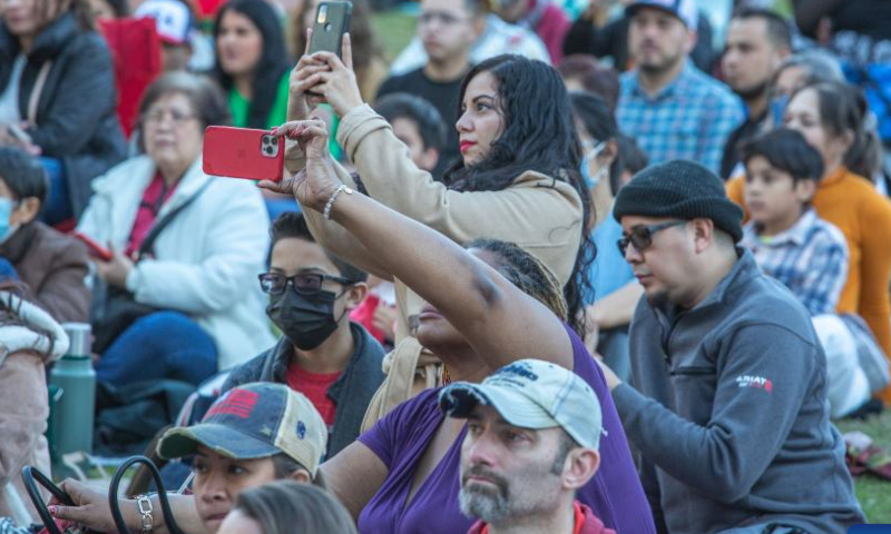 Spectators watch performances to celebrate the Lunar New Year at Discovery Green in downtown Houston, the United States, on Jan. 22, 2023. A Lunar New Year celebration was held on Sunday at Discovery Green, a landmark public park in downtown Houston. (Photo by Chengyue Lao/Xinhua)