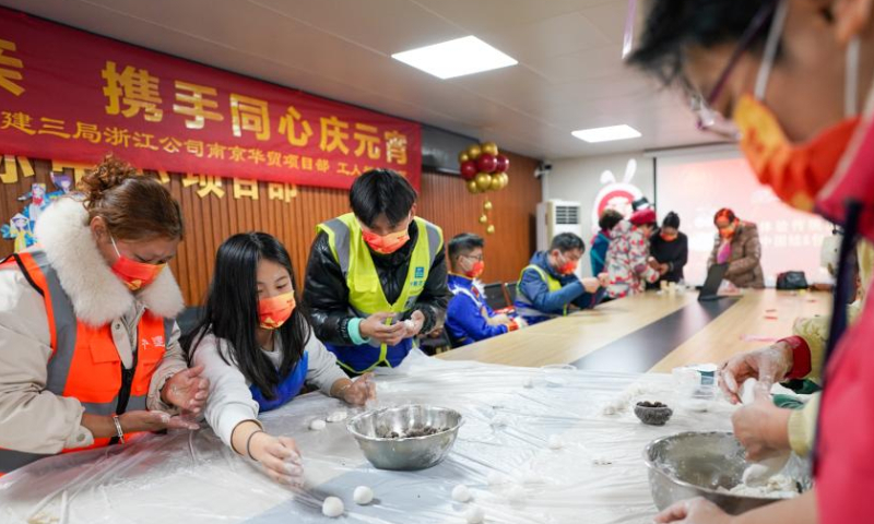 Construction workers of the China Construction Third Engineering Bureau Co., Ltd. and local residents make tangyuan, a kind of round and sweet dumpling made of glutinous rice flour, in Nanjing, east China's Jiangsu Province, Feb. 4, 2023. The Lantern Festival, the 15th day of the first month of the Chinese lunar calendar, falls on Feb. 5 this year. Various folk cultural activities were held across the country to welcome the upcoming festival. Photo: Xinhua