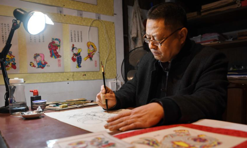 An artist makes woodblock paintings at the Wuqiang woodblock new year painting museum in Wuqiang County, north China's Hebei Province, Feb. 3, 2023. Wuqiang County has made efforts to pass on and promote the culture of Wuqiang woodblock new year painting, a national intangible cultural heritage listed in 2006. A series of cultural and creative products made with modern technology has been introduced to attract youngsters. Photo: Xinhua