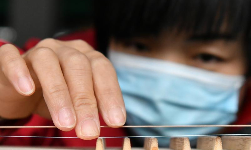 A worker tunes a traditional Chinese musical instrument at a workshop in Suning County, north China's Hebei Province, Feb. 18, 2023. Photo: Xinhua