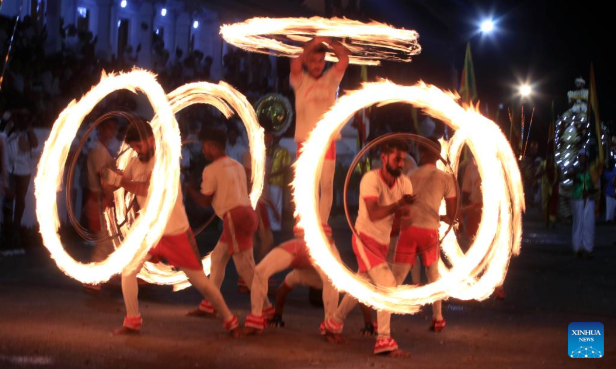 Fire acrobats perform at a celebration during the Duruthu Perahera festival at a temple in Kelaniya, Sri Lanka, on Jan 5, 2023. Photo:Xinhua