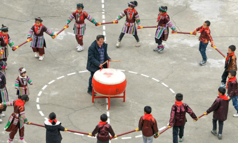 Students and teacher Meng Rongda (C) practice traditional dance of Yao ethnic group at the Zhongzhai education spot in Xishan Town of Congjiang County, Qiandongnan Miao and Dong Autonomous Prefecture, southwest China's Guizhou Province, Feb. 16, 2023. Zhongzhai education spot, located in the remote mountainous area of Guizhou Province, has only one teacher and 16 students of Yao ethnic group. In recent years, the conditions of this mini primary school have been greatly improved with the help of local government and community. Photo: Xinhua