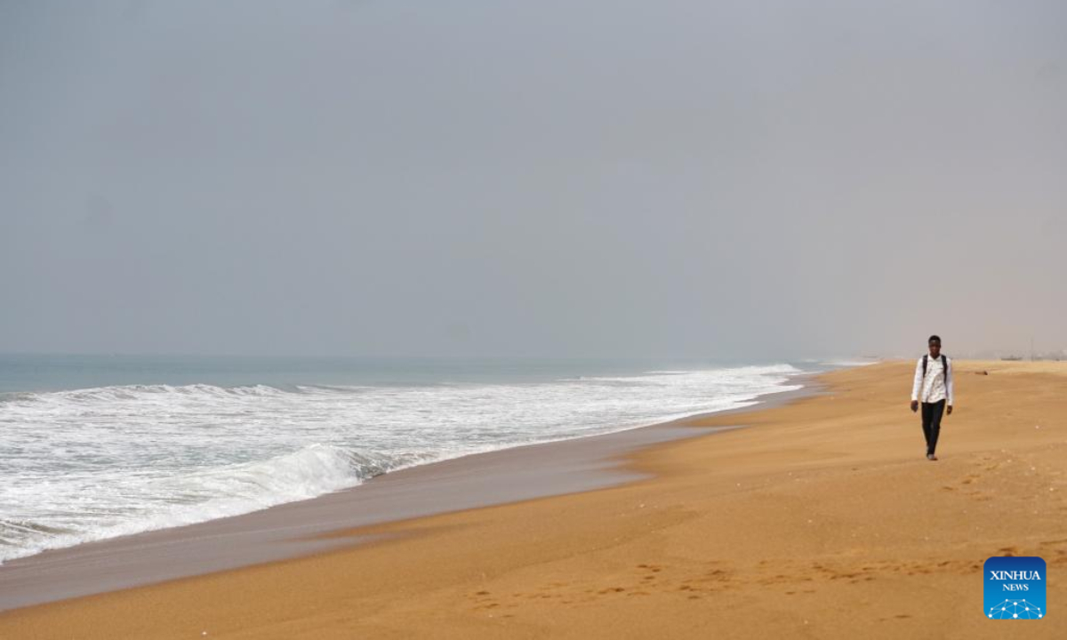 A man takes a walk on the beach in Cotonou, Benin, Jan 12, 2023. Photo:Xinhua