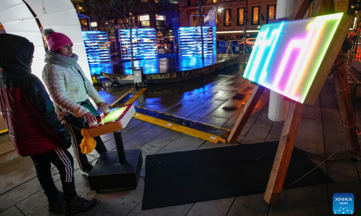 People experience an interactive art installation displayed on a street during the Winter Arts Festival in Vancouver, British Columbia, Canada, on Feb 16, 2023. The annual outdoor festival featuring augmented reality art and light installations will last till Feb 23. Photo:Xinhua