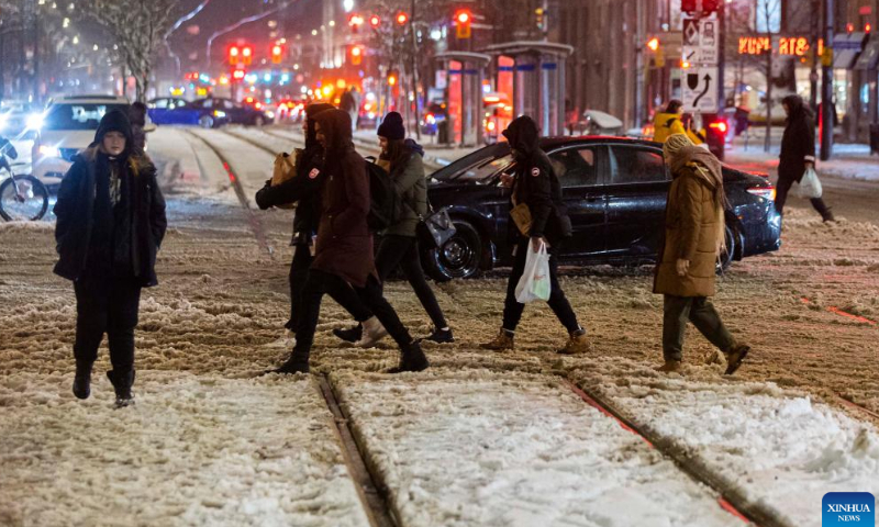 People walk on a snow-covered street in Toronto, Canada, on Jan. 25, 2023. Photo: Xinhua