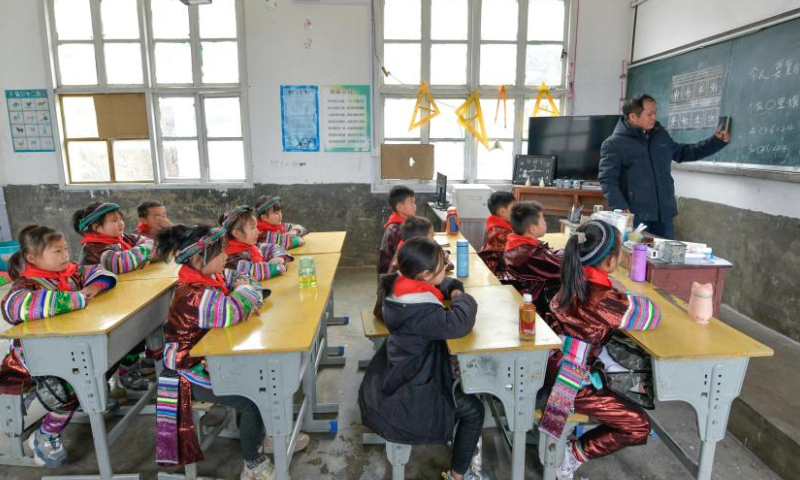 Teacher Meng Rongda gives a lesson at the Zhongzhai education spot in Xishan Town of Congjiang County, Qiandongnan Miao and Dong Autonomous Prefecture, southwest China's Guizhou Province, Feb. 16, 2023. Zhongzhai education spot, located in the remote mountainous area of Guizhou Province, has only one teacher and 16 students of Yao ethnic group. In recent years, the conditions of this mini primary school have been greatly improved with the help of local government and community. Photo: Xinhua