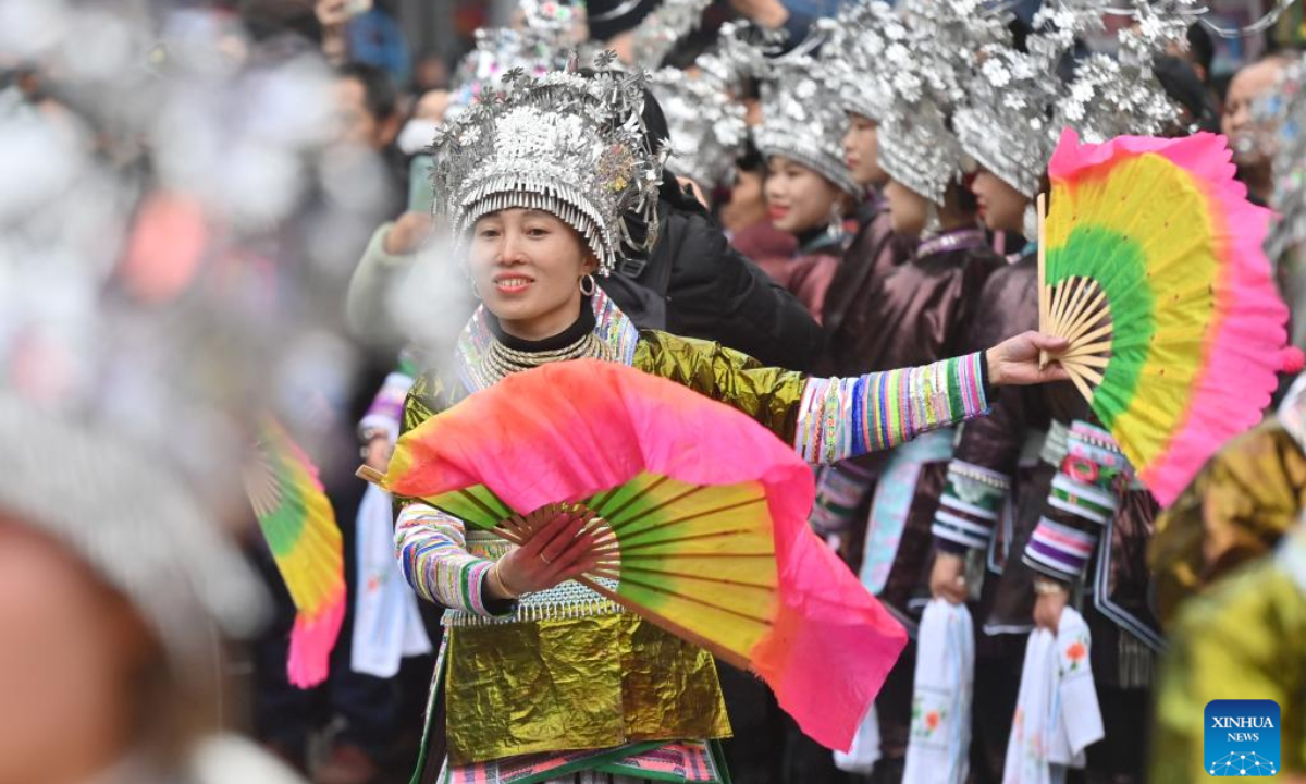 Girls of Miao ethnic group perform dancing during the 