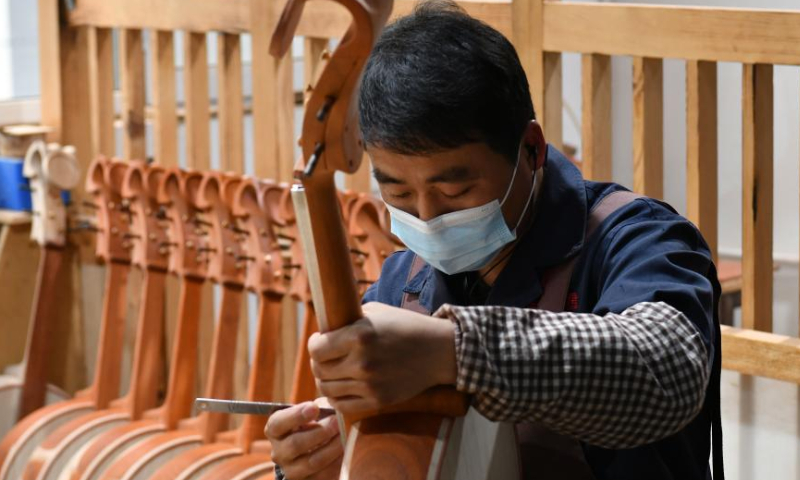 A worker makes a traditional Chinese musical instrument at a workshop in Suning County, north China's Hebei Province, Feb. 18, 2023. Photo: Xinhua