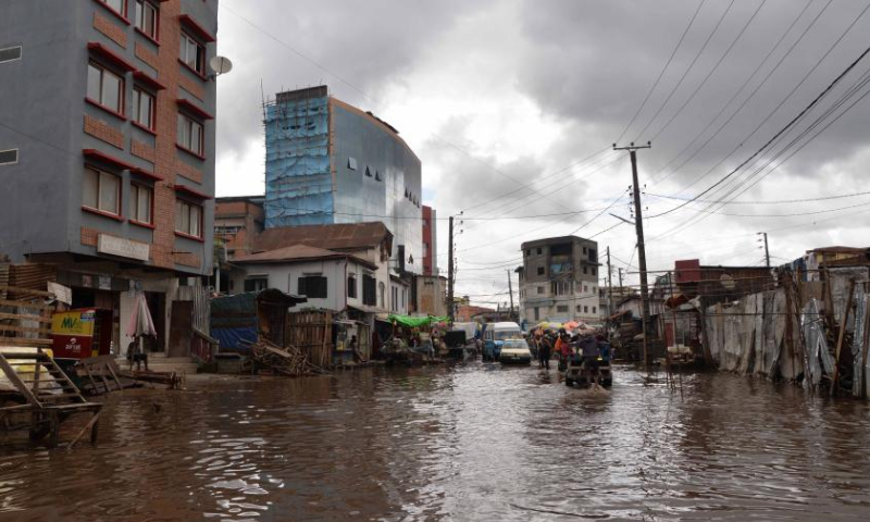 People are seen on a flooded area in Antananarivo, Madagascar, on Jan. 25, 2023. The death toll has risen to 16 with 19 people still missing after the strong tropical storm Cheneso hit Madagascar, according to the latest report released Thursday by the National Office for Risk and Disaster Management (BNGRC). Photo: Xinhua