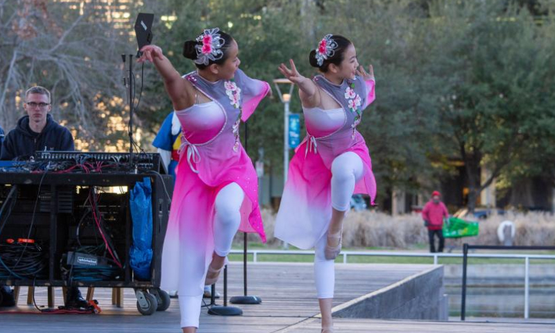 Dancers perform during a Lunar New Year celebration at Discovery Green in downtown Houston, the United States, on Jan. 22, 2023. The Lunar New Year celebration was held on Sunday at Discovery Green, a landmark public park in downtown Houston. (Photo by Chengyue Lao/Xinhua)