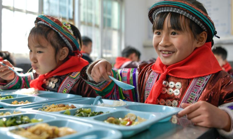 Students have free lunch at the Zhongzhai education spot in Xishan Town of Congjiang County, Qiandongnan Miao and Dong Autonomous Prefecture, southwest China's Guizhou Province, Feb. 16, 2023. Zhongzhai education spot, located in the remote mountainous area of Guizhou Province, has only one teacher and 16 students of Yao ethnic group. In recent years, the conditions of this mini primary school have been greatly improved with the help of local government and community. Photo: Xinhua