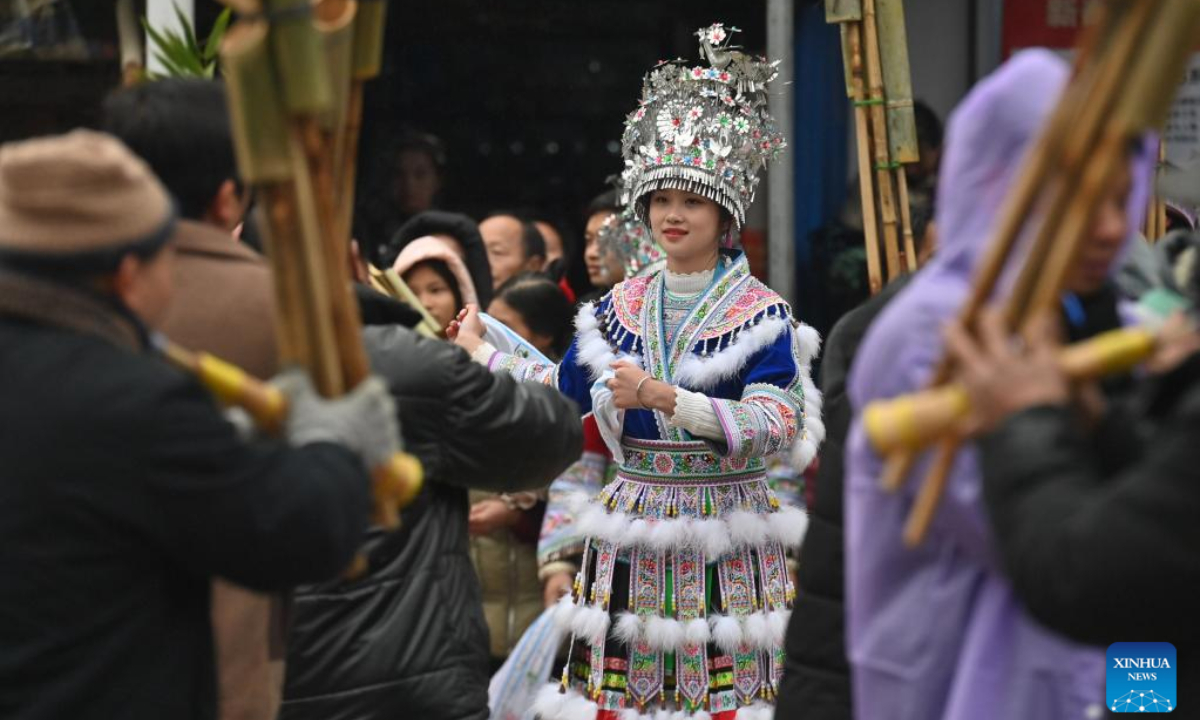 Girls of Miao ethnic group perform dancing during the 