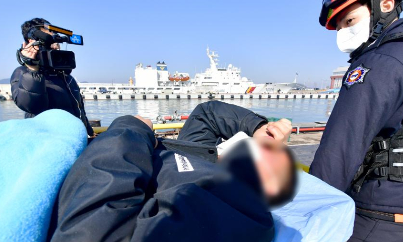 A rescued fisherman from a capsized fishing boat is being transferred to hospital at a port in Mokpo city, South Jeolla province, South Korea, on Feb. 5, 2023. Nine people went missing as a fishing boat capsized in the waters off southwestern South Korea, Yonhap news agency reported on Sunday. Photo: Xinhua