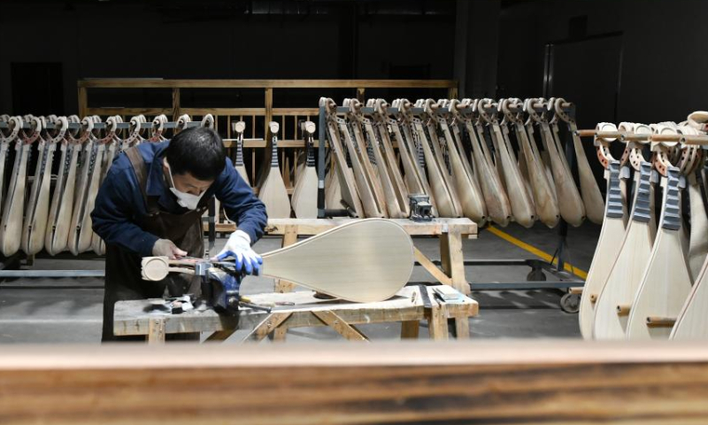 A worker makes a traditional Chinese musical instrument at a workshop in Suning County, north China's Hebei Province, Feb. 18, 2023. Photo: Xinhua