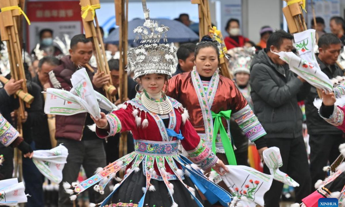 Girls of Miao ethnic group perform dancing during the 