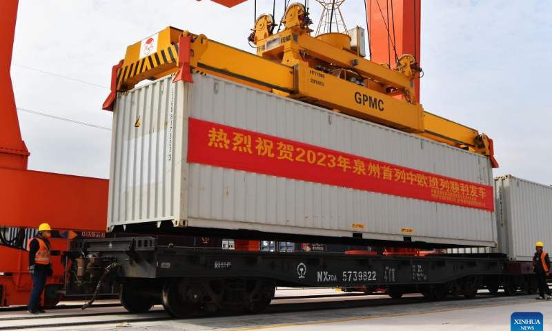 A container is loaded on a China-Europe freight train at Huangtang railway station on Xingguo-Quanzhou railway in Huian County, Quanzhou City of southeast China's Fujian Province, Feb. 3, 2023. This is the first China-Europe freight train departing from Quanzhou this year, and also the first China-Europe freight train running on Xingguo-Quanzhou railway since its operation. Photo: Xinhua