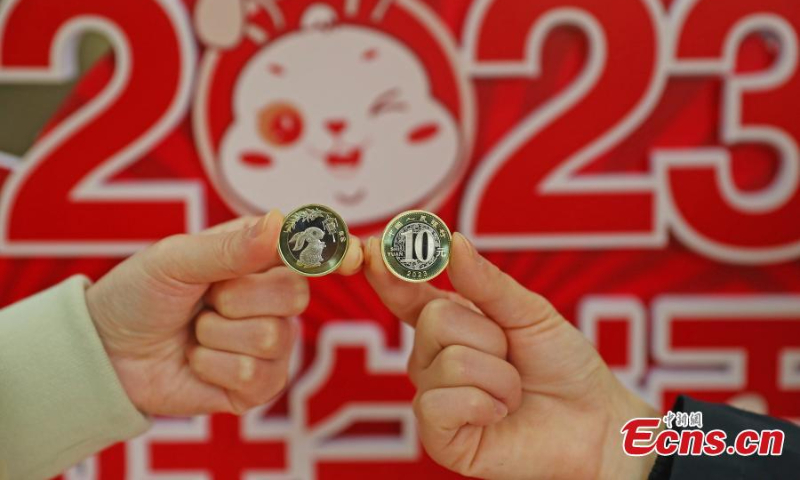 Staff members display the commemorative coins for the Year of the Rabbit at the Jiangxi branch of the Postal Saving Bank of China in Nanchang, east China's Jiangxi Province, Jan. 5, 2023. (Photo: China News Service/Liu Zhankun)