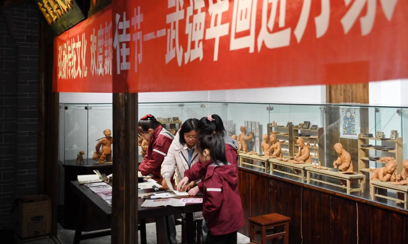 Children learn making woodblock new year paintings at the Wuqiang woodblock new year painting museum in Wuqiang County, north China's Hebei Province, Feb. 3, 2023. Wuqiang County has made efforts to pass on and promote the culture of Wuqiang woodblock new year painting, a national intangible cultural heritage listed in 2006. A series of cultural and creative products made with modern technology has been introduced to attract youngsters. Photo: Xinhua