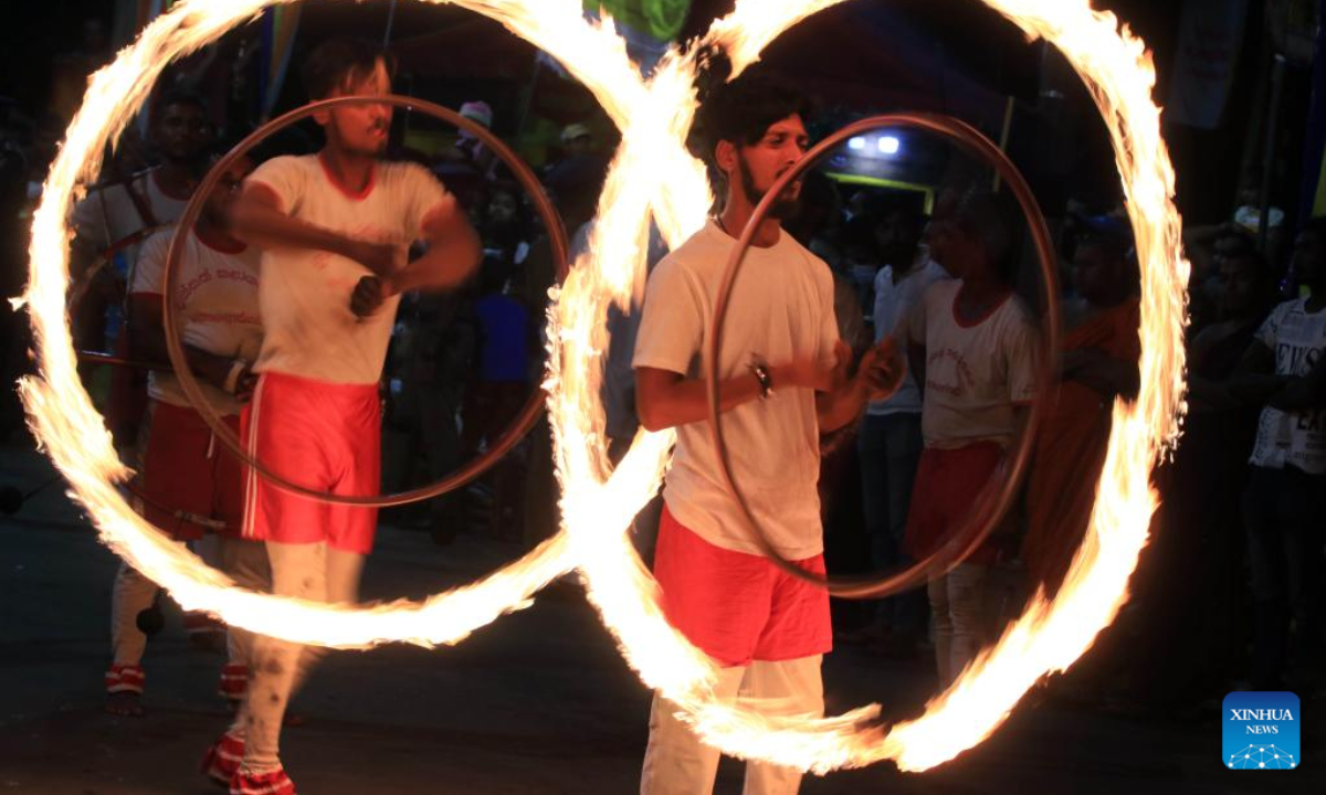 Fire acrobats perform at a celebration during the Duruthu Perahera festival at a temple in Kelaniya, Sri Lanka, on Jan 5, 2023. Photo:Xinhua