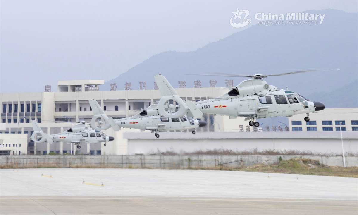 Three helicopters attached to a ship-borne helicopter regiment of the navy under the PLA Southern Theater Command hover in formation during a round-the-clock training exercise in late January, 2023. Photo: China Military