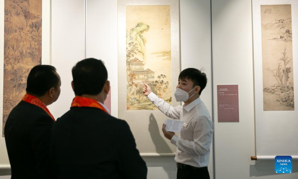 Visitors watch the works of the Ancient Chinese Landscape Painting Exhibition themed 