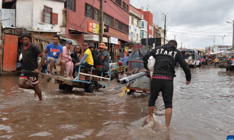 People are seen on a flooded area in Antananarivo, Madagascar, on Jan. 25, 2023. The death toll has risen to 16 with 19 people still missing after the strong tropical storm Cheneso hit Madagascar, according to the latest report released Thursday by the National Office for Risk and Disaster Management (BNGRC). Photo: Xinhua