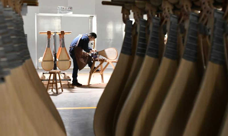 A worker makes a traditional Chinese musical instrument at a workshop in Suning County, north China's Hebei Province, Feb. 18, 2023. Photo: Xinhua