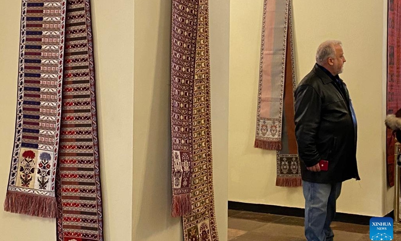 A man visits the Lithuanian and Polish Traditional Costume Exhibition in Vilnius, Lithuania, Jan. 11, 2023. The exhibition, displaying the two countries' traditional costumes and tapestries, was jointly organized by the national cultural heritage departments of Lithuania and Poland.(Photo: Xinhua)