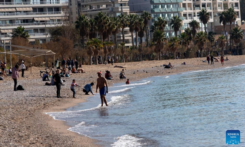 People spend time at a beach in Faliro, a southern suburb of Athens, Greece, on Jan. 6, 2023. Greece has been experiencing unseasonably warm temperatures this winter, prompting people to head for the beach instead of the ski resorts. However, the mild weather leaves scientists concerned.(Photo: Xinhua)